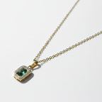 SVORA gold-plated stainless steel necklace with emerald pendant surrounded by small clear stones.