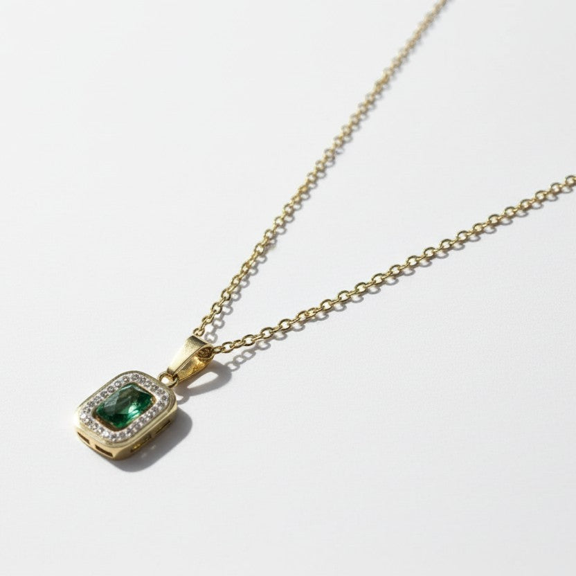 SVORA gold-plated stainless steel necklace with emerald pendant surrounded by small clear stones.