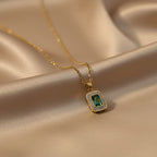 SVORA gold-plated stainless steel necklace with a rectangular emerald pendant surrounded by small clear stones.