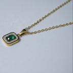 SVORA gold-plated stainless steel necklace with emerald pendant surrounded by clear crystals. Waterproof and anti-tarnish.