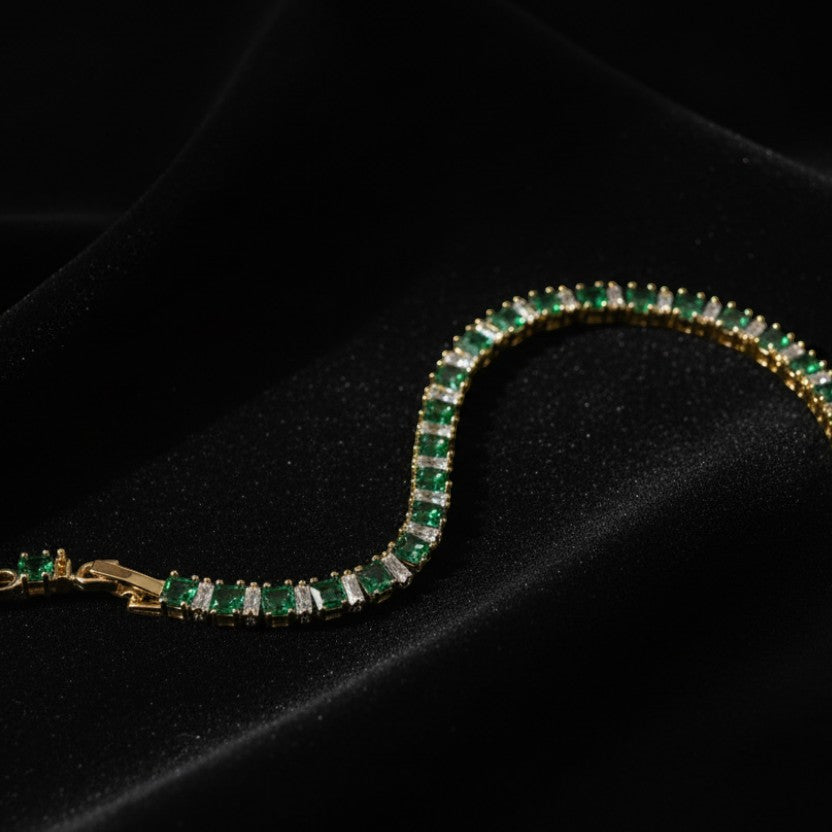 SVORA gold-plated stainless steel tennis bracelet with emerald green and clear baguette-cut stones