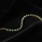 SVORA gold-plated stainless steel tennis bracelet with emerald green and clear baguette-cut stones