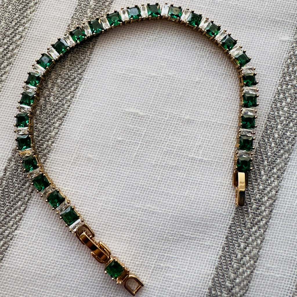SVORA Emerald Tennis Adjustable Bracelet with alternating emerald green and clear square-cut stones, 18k gold-plated stainless steel.