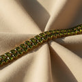 SVORA gold-plated tennis bracelet with double row of oval emerald green CZ stones. Fold-over clasp.