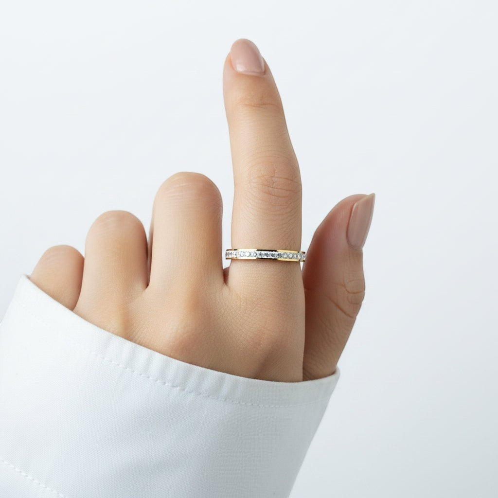 SVORA Lumiere Stack Eternity Ring, a thin gold band with a full circle of small clear stones.