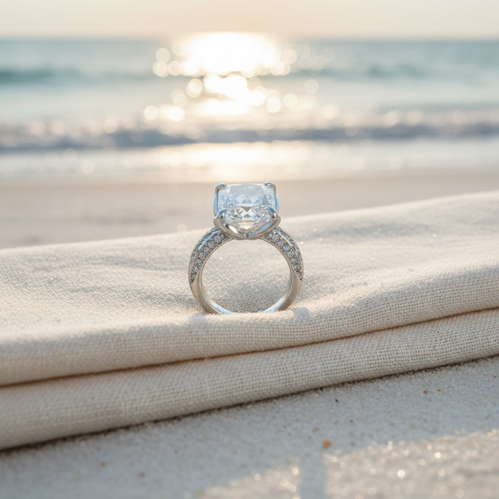 SVORA Ethereal Botanica Solitaire Ring with princess-cut clear stone and leaf-motif band on a beach.