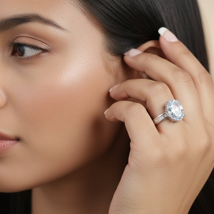 SVORA Ethereal Diamond Solitaire Ring with oval-cut clear stone and baguette band on a woman's hand.