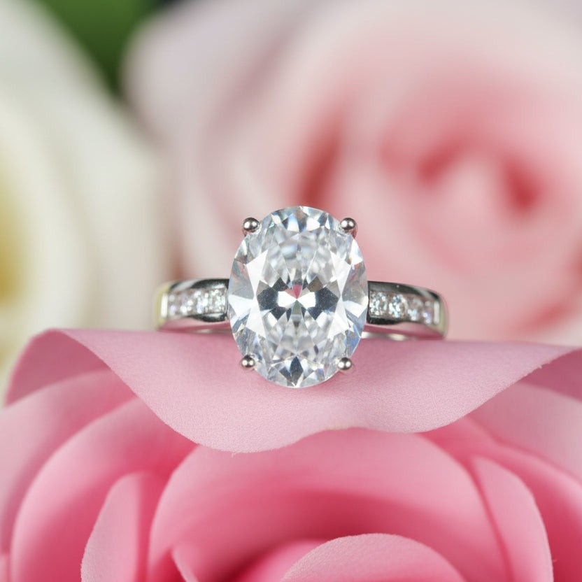 SVORA Ethereal Diamond Solitaire Ring with oval-cut clear stone and channel-set baguette band in rhodium-plated stainless steel.