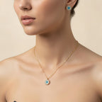 SVORA gold tone stainless steel evil eye necklace and matching earrings set with cubic zirconia.