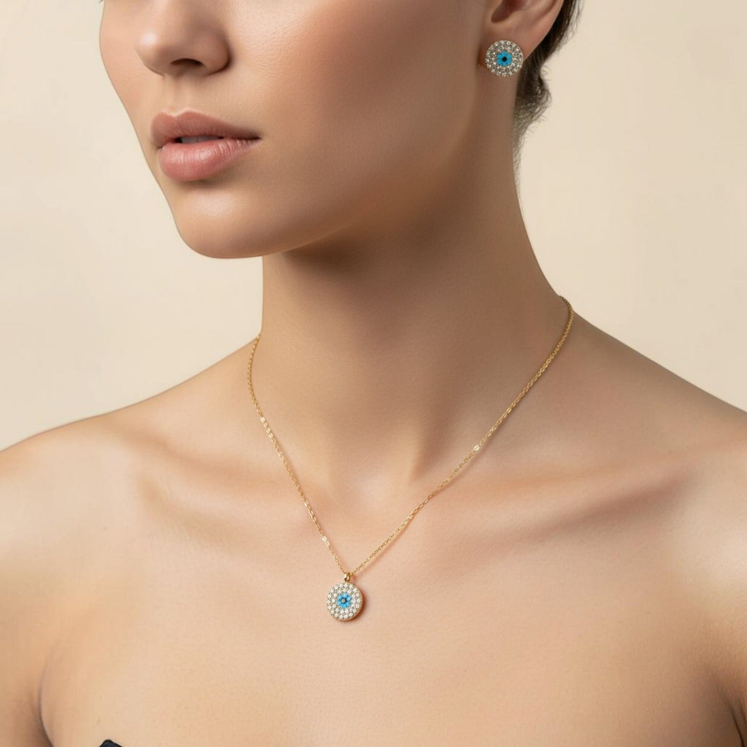 SVORA gold tone stainless steel evil eye necklace and matching earrings set with cubic zirconia.
