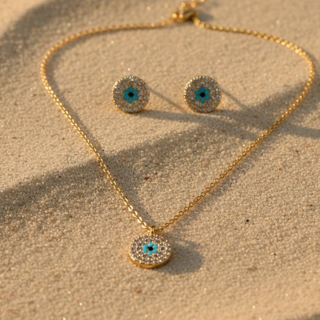 SVORA gold tone stainless steel evil eye necklace and earrings set with cubic zirconia and turquoise detail.