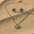SVORA gold tone stainless steel evil eye necklace and earrings set with cubic zirconia and turquoise detail.