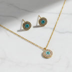 SVORA gold tone stainless steel evil eye necklace and earrings set with cubic zirconia and turquoise detail.