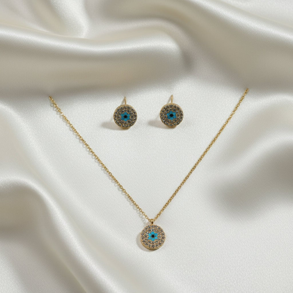 SVORA gold tone stainless steel evil eye necklace and earrings set with cubic zirconia and turquoise detail.