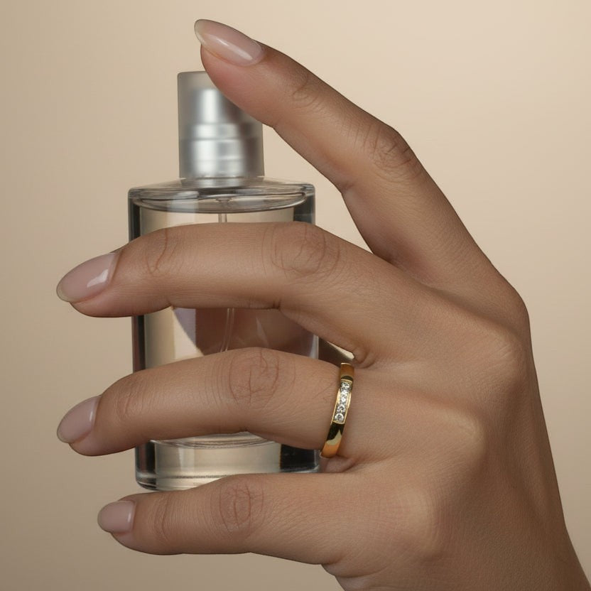 SVORA gold plated stainless steel Lumiere Promise five stone ring with channel-set cubic zirconia on a slim band.
