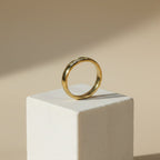 SVORA Lumiere Promise Five Stone Ring in gold-plated stainless steel with five small stones set in a channel on a slim band.