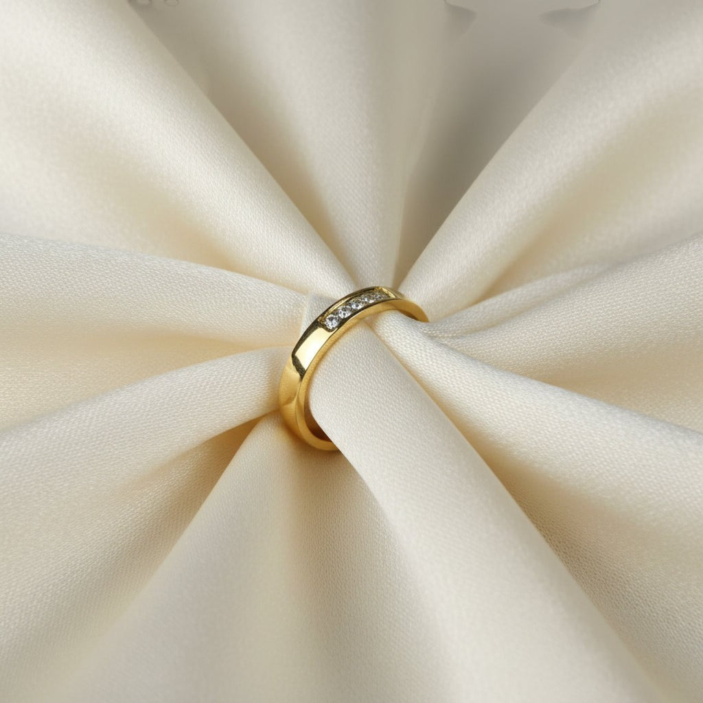 SVORA Lumiere Promise Five Stone Ring in gold-plated stainless steel with a high polish finish. Features five small stones set in a channel on a slim band.