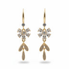 SVORA Flora Stones Dangler Earrings: Gold-tone stainless steel with 18k gold plating, featuring clear crystal flower and leaf charms.