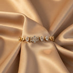 SVORA gold plated stainless steel bracelet with CZ flower and leaf links, adjustable fold-over clasp.