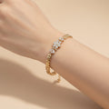 SVORA gold plated stainless steel bracelet with CZ flowers and leaf links. Adjustable fold-over clasp.