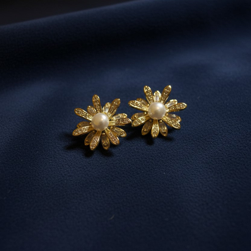 SVORA gold flower bloom pearl stud earrings with pavé and baguette crystals.