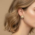 SVORA gold flower bloom pearl stud earrings with pavé and baguette crystals
