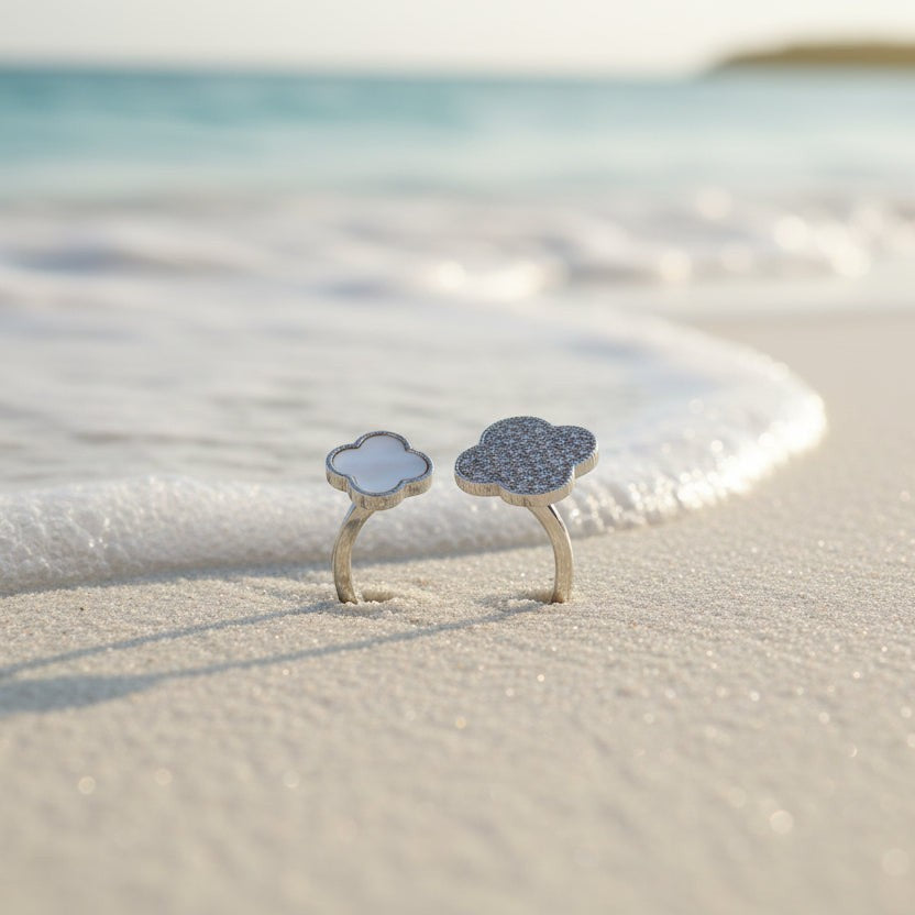 SVORA Toi et Moi Fortune Clover Ring with one clover pavé-set with clear stones and one with mother-of-pearl on a silver band.
