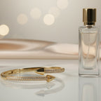 SVORA gold bypass bracelet with two pavé-encrusted arrowheads facing each other. 18K gold plated stainless steel.