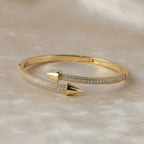 SVORA gold plated stainless steel bypass bracelet with two pavé diamond arrowheads