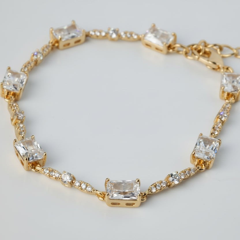 SVORA gold plated tennis bracelet with emerald-cut CZ baguettes and round stones, 18K gold, stainless steel.
