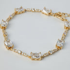 SVORA gold plated tennis bracelet with emerald-cut CZ baguettes and round stones, 18K gold, stainless steel.