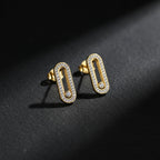 SVORA gold tone stainless steel dangle earrings with pavé cubic zirconia bar and moving stone detail.