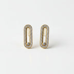 SVORA gold tone stainless steel dangle earrings with pavé cubic zirconia bars and a central moving stone.