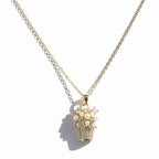 SVORA gold-tone stainless steel necklace with a basket pendant adorned with pearls and cubic zirconia stones.