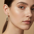 SVORA gold-tone stainless steel bow dangle earrings with pave-set diamonds