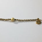 SVORA gold plated stainless steel bracelet with CZ stones and a textured gold ball accent. Adjustable.