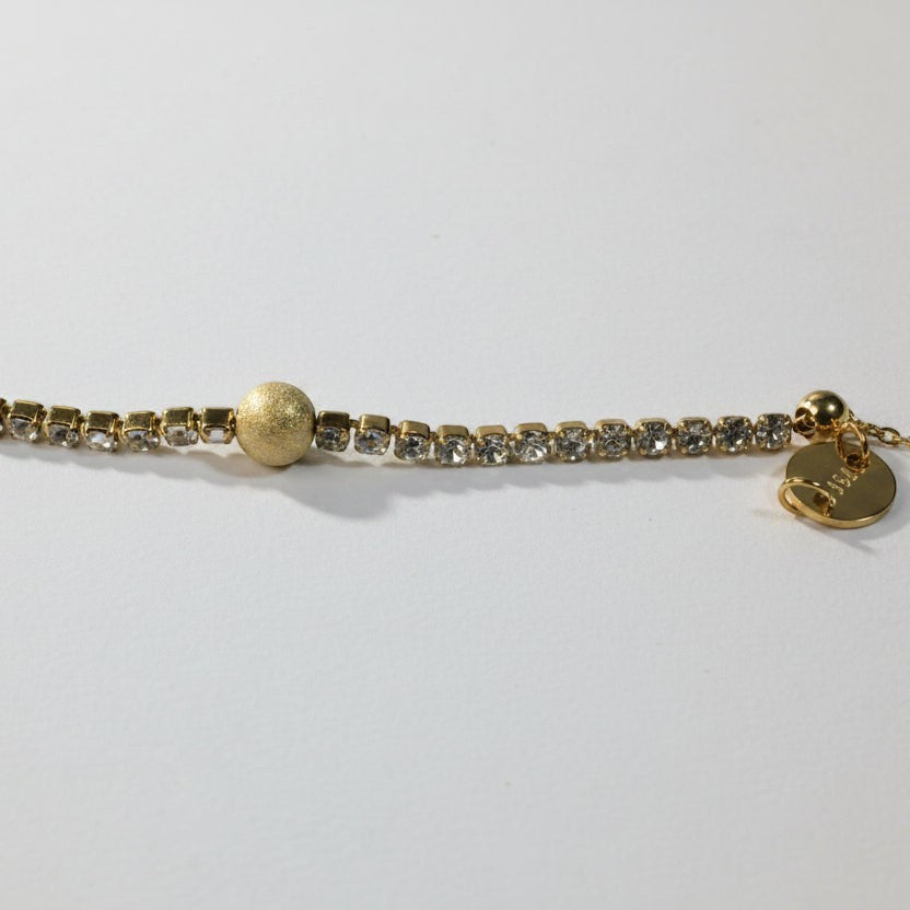 SVORA gold plated stainless steel bracelet with CZ stones and a textured gold ball accent. Adjustable.