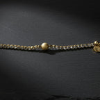 SVORA gold plated stainless steel bracelet with CZ stones and a textured gold ball accent. Adjustable.