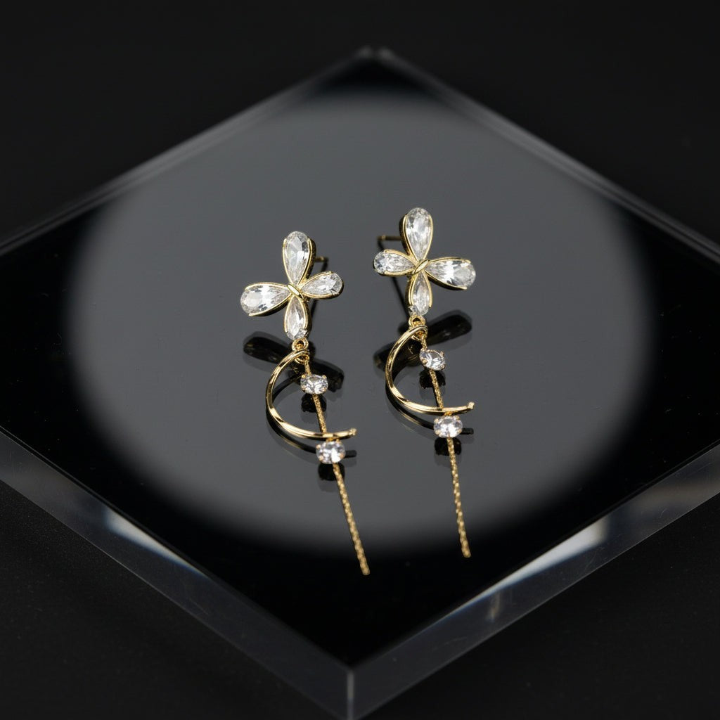 SVORA gold tone stainless steel dangle earrings with cubic zirconia butterfly and crescent moon design.