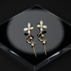 SVORA gold tone stainless steel dangle earrings with cubic zirconia butterfly and crescent moon design.