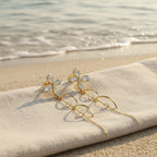 SVORA gold tone stainless steel dangle earrings with cubic zirconia butterfly tops and dual chains.