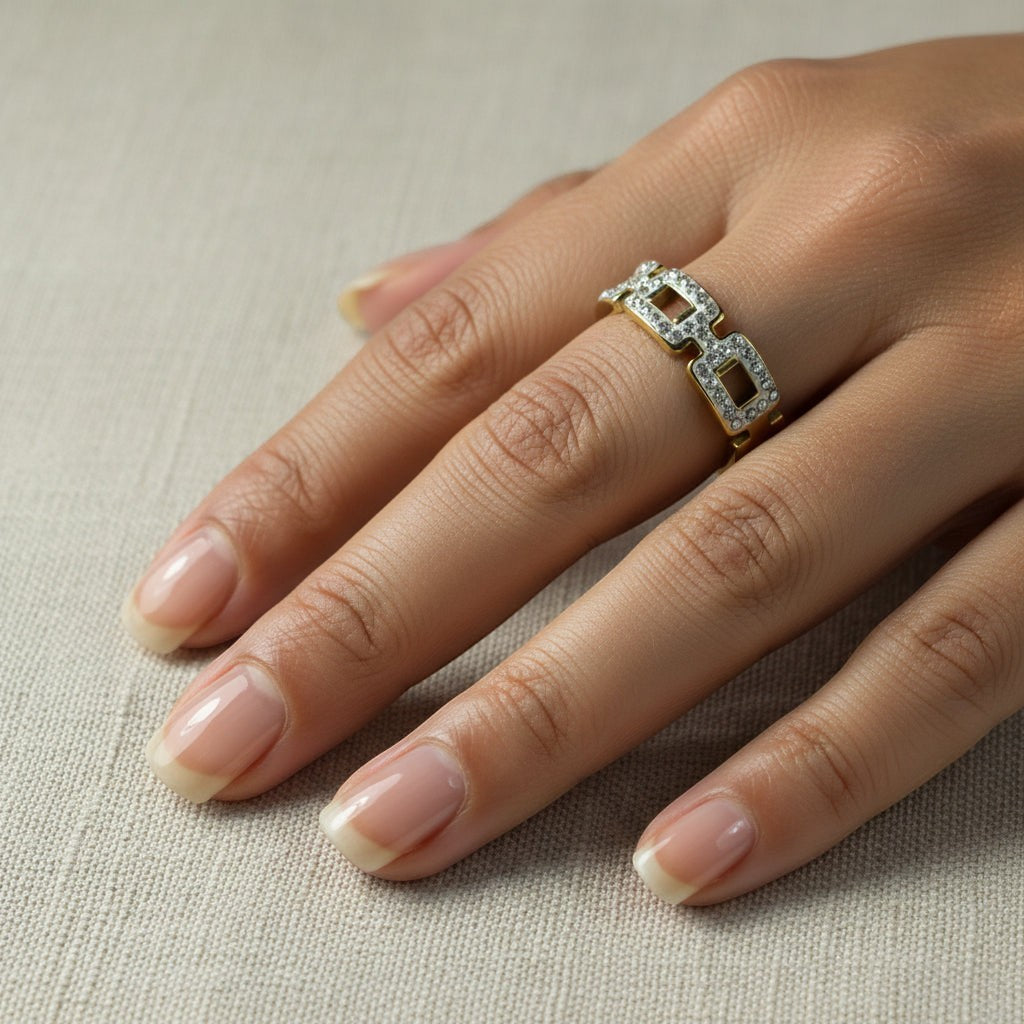 SVORA gold chain link ring with clear stones on a hand. Waterproof, anti-tarnish, hypoallergenic.