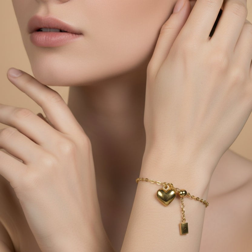 SVORA gold plated stainless steel bracelet with heart and rectangle charms, adjustable with lobster clasp.