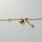 SVORA gold plated stainless steel bracelet with clover, heart, and rectangle charms. Adjustable.