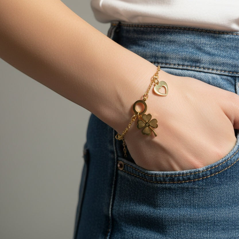 SVORA gold-plated stainless steel bracelet with a clover, heart, and circle charm. Adjustable.