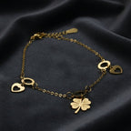 SVORA gold plated stainless steel bracelet with clover and heart charms. Waterproof and anti-tarnish.