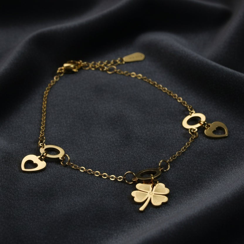 SVORA gold plated stainless steel bracelet with clover and heart charms. Waterproof and anti-tarnish.