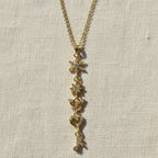 SVORA gold-plated stainless steel necklace with snowflake, star, butterfly, heart, and musical note charms.