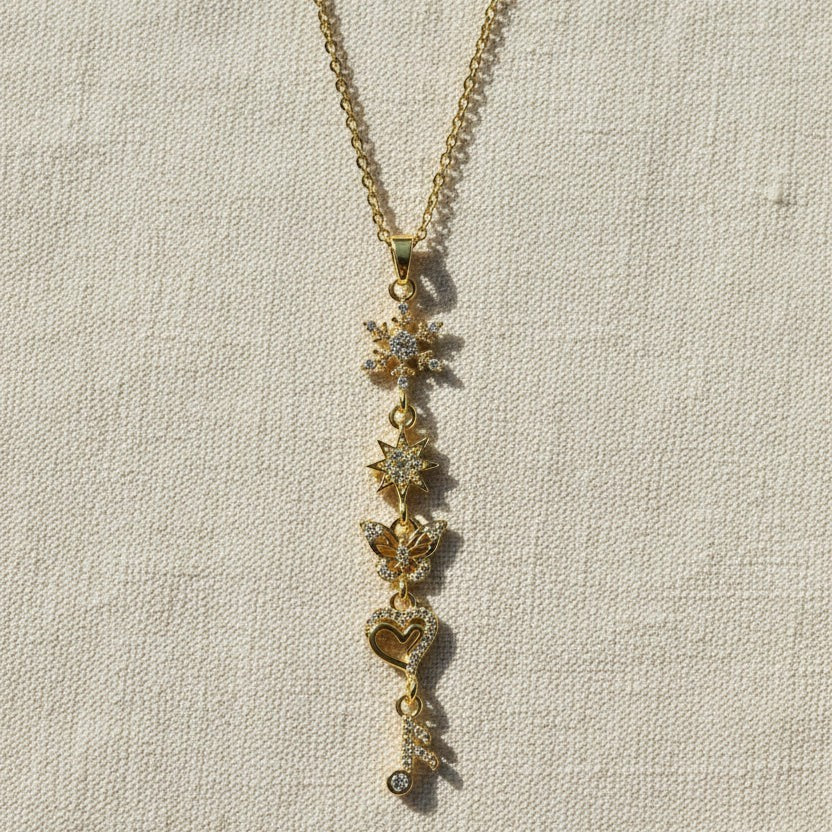 SVORA gold-plated stainless steel necklace with snowflake, star, butterfly, heart, and musical note charms.