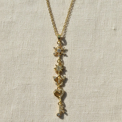 SVORA gold-plated stainless steel necklace with snowflake, star, butterfly, heart, and musical note charms.